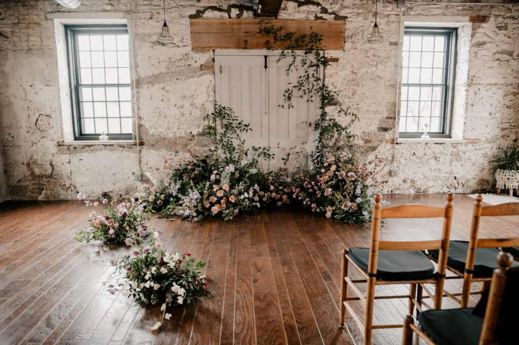 Indoor ceremony space at the Sinclair of Skaneateles with florals done by Beck and Forth Co.